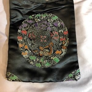 Small purse with complex mandala on shiny black.